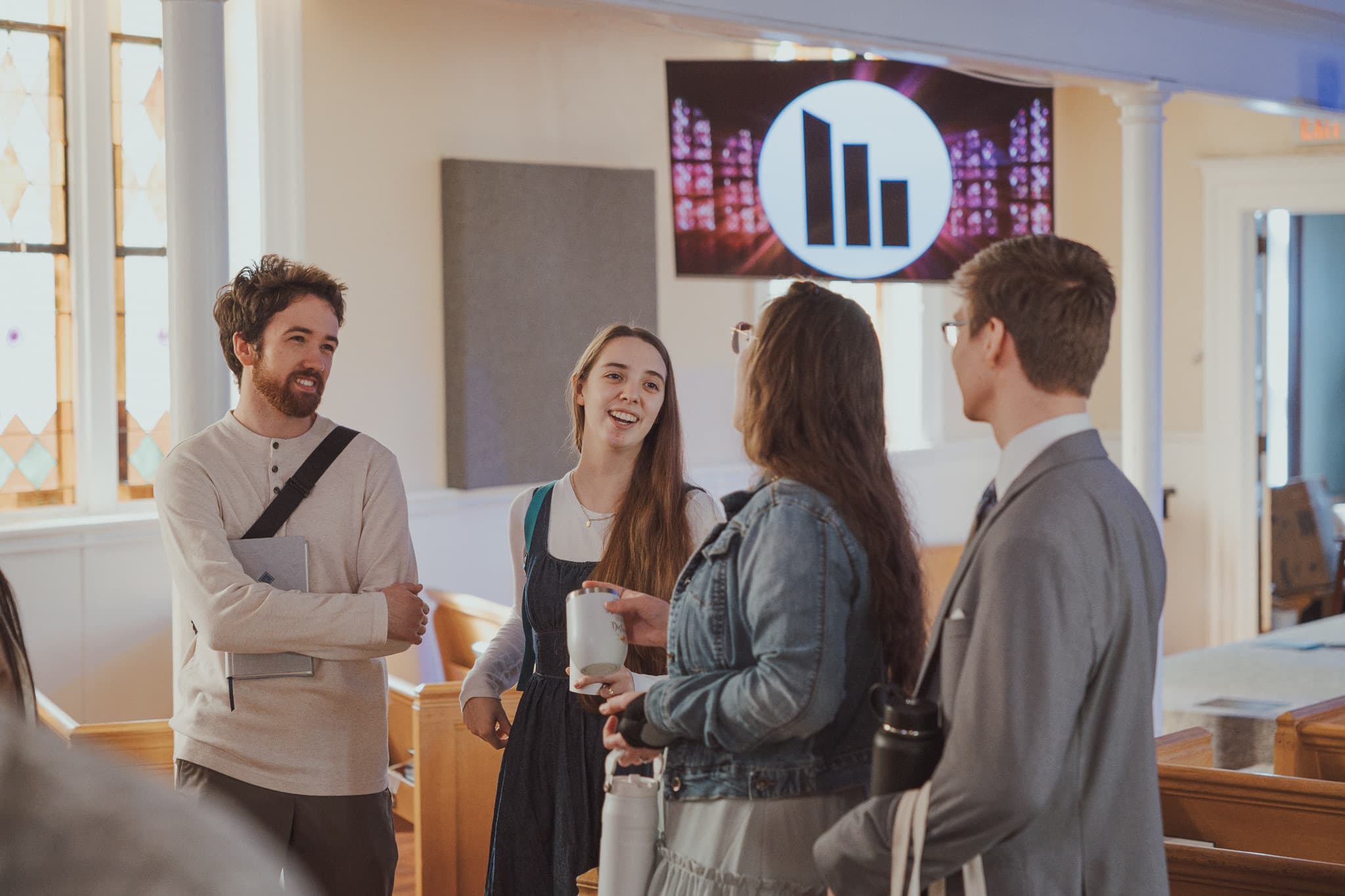 People arriving and talking at River City Church
