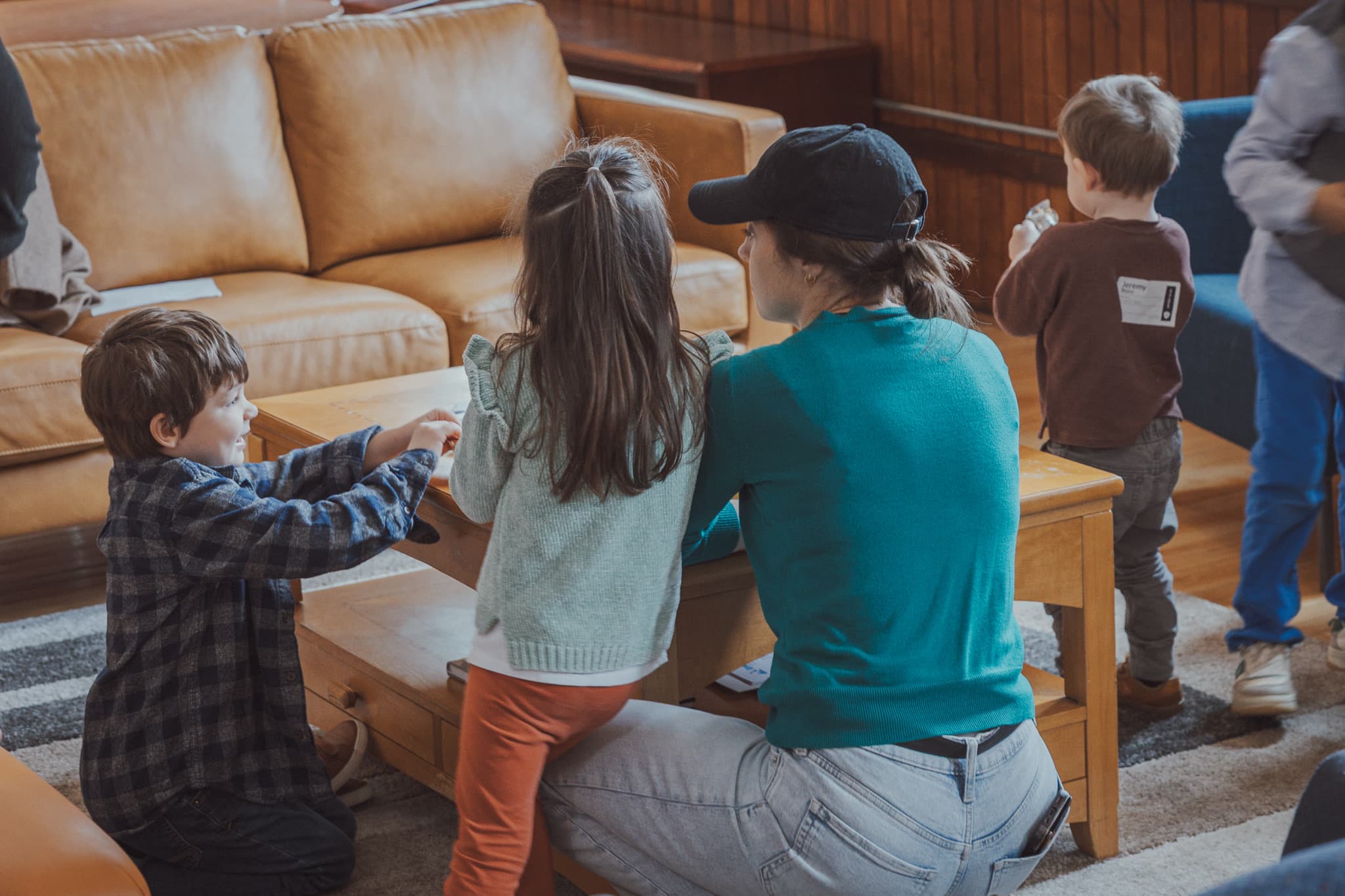 A River City Kids volunteer helping children play and settle in